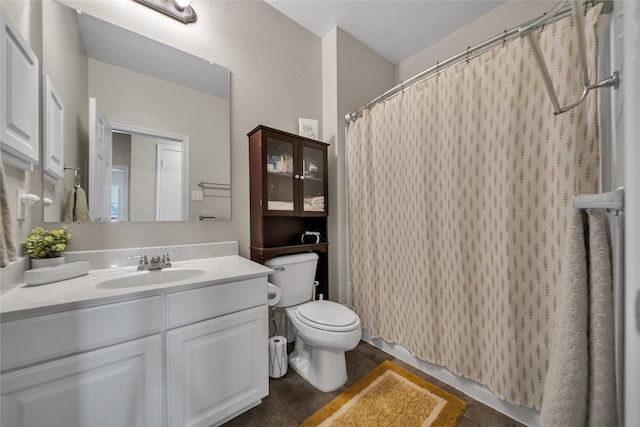 bathroom featuring tile patterned floors, a shower with curtain, toilet, and vanity