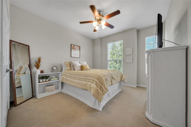 bedroom with baseboards, light colored carpet, and ceiling fan