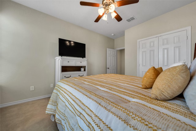 carpeted bedroom featuring visible vents, baseboards, a closet, and ceiling fan