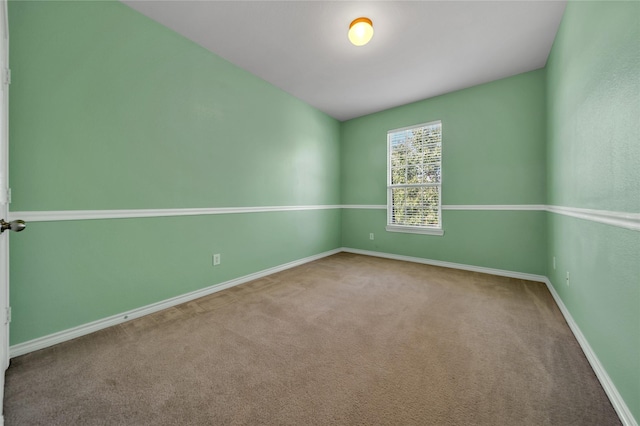 carpeted empty room with baseboards