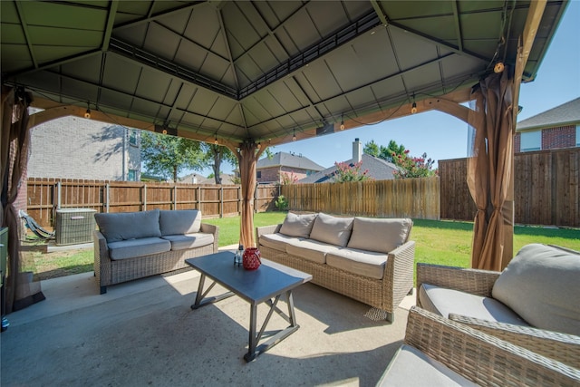 view of patio with a gazebo, an outdoor hangout area, and a fenced backyard