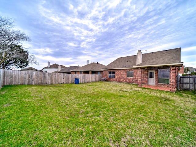 view of yard with a fenced backyard and a patio area