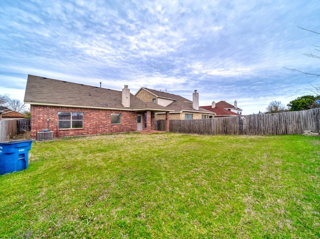 view of yard featuring a fenced backyard and central AC