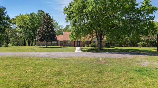 view of front of property with brick siding and a front lawn