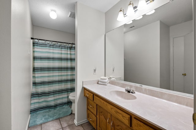 full bathroom with tile patterned flooring, visible vents, toilet, vanity, and a textured ceiling