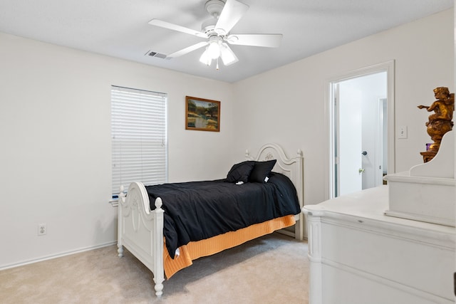 bedroom with visible vents, light carpet, and a ceiling fan