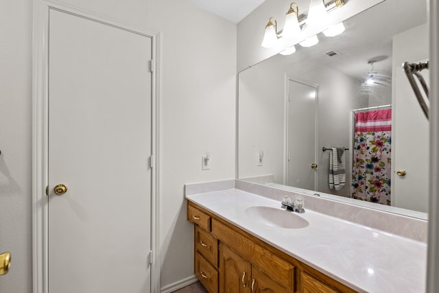 bathroom featuring curtained shower and vanity