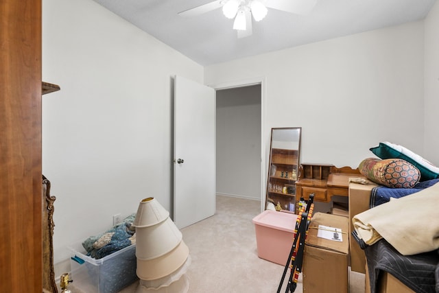 interior space featuring light colored carpet and a ceiling fan