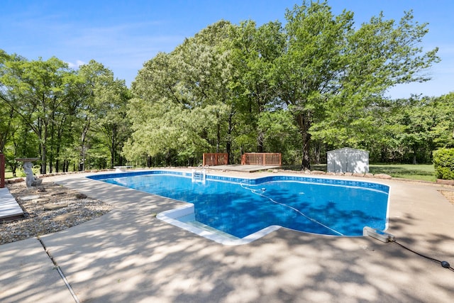 pool featuring a storage shed and an outdoor structure