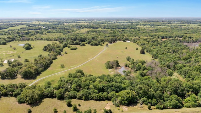 birds eye view of property featuring a forest view