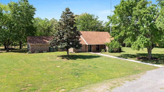 ranch-style house with brick siding and a front lawn