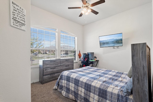 carpeted bedroom with baseboards and a ceiling fan