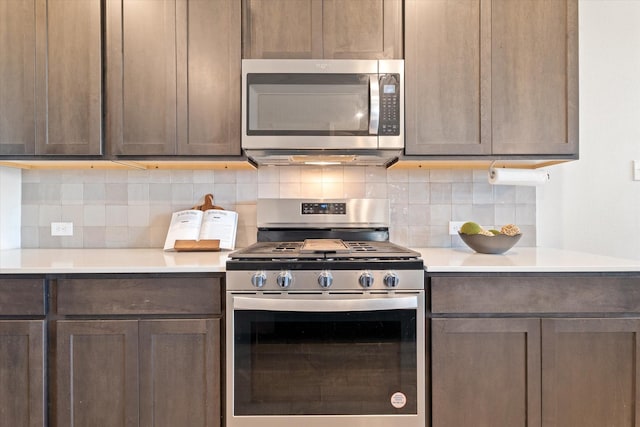 kitchen featuring decorative backsplash, appliances with stainless steel finishes, and light countertops