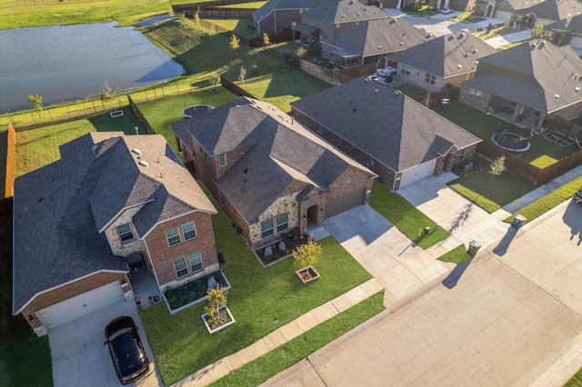 birds eye view of property with a water view and a residential view