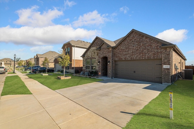 view of front of home with brick siding, driveway, a front yard, and central AC