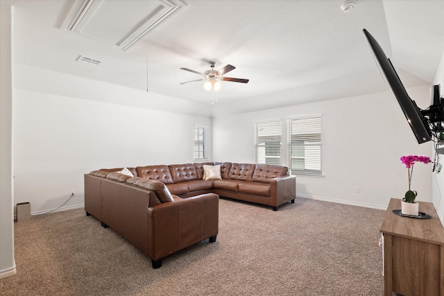 living area featuring a ceiling fan, baseboards, visible vents, and light carpet