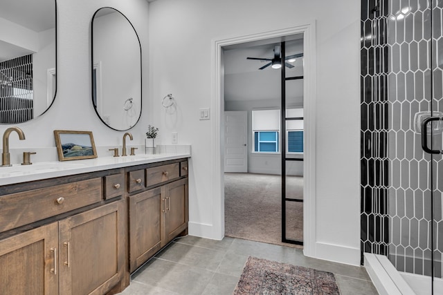 full bathroom with a tile shower, double vanity, and a sink