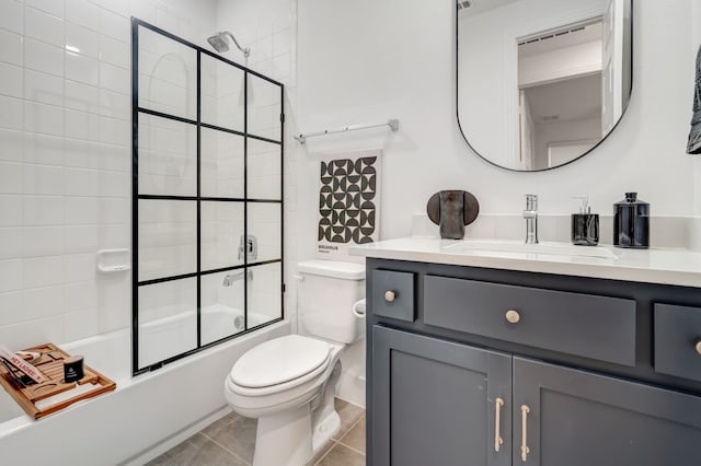 full bath featuring vanity, toilet, combined bath / shower with glass door, and tile patterned flooring