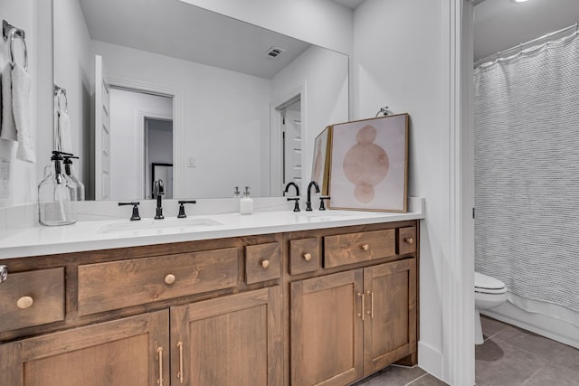 bathroom featuring a shower with curtain, toilet, a sink, tile patterned flooring, and double vanity