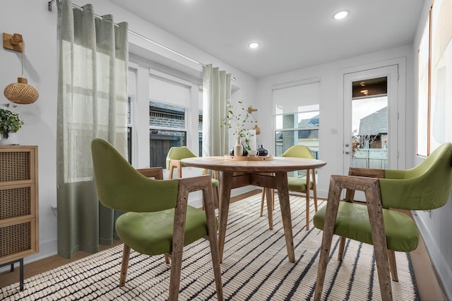 dining space with recessed lighting, baseboards, and wood finished floors