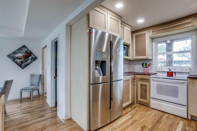 kitchen with recessed lighting, stainless steel appliances, baseboards, and light wood-style flooring