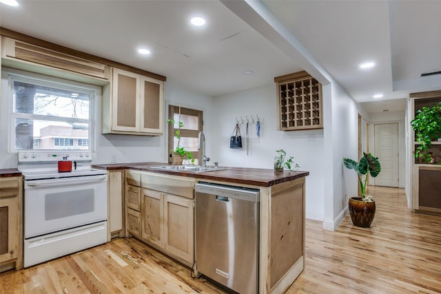 kitchen featuring butcher block countertops, light wood-style flooring, a sink, stainless steel dishwasher, and white range with electric stovetop