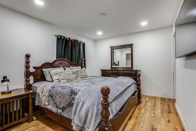 bedroom with recessed lighting and wood finished floors