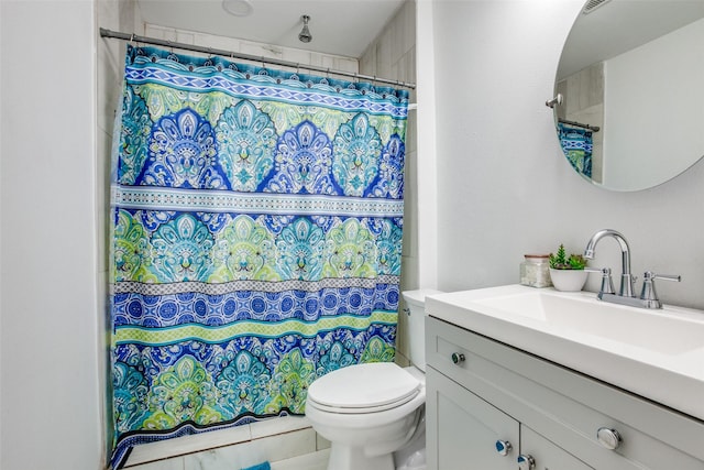 bathroom featuring vanity, a shower with shower curtain, and toilet