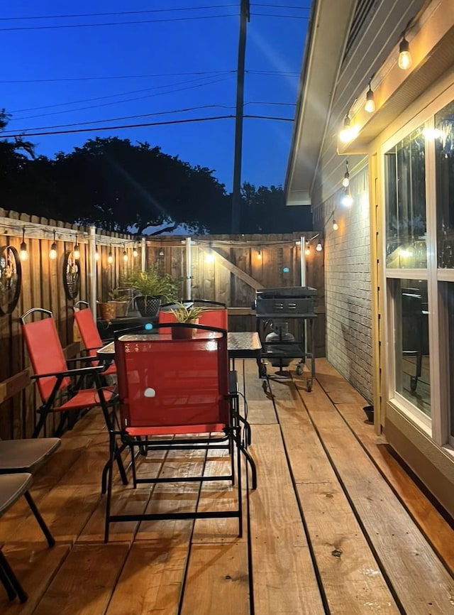 deck at twilight with fence