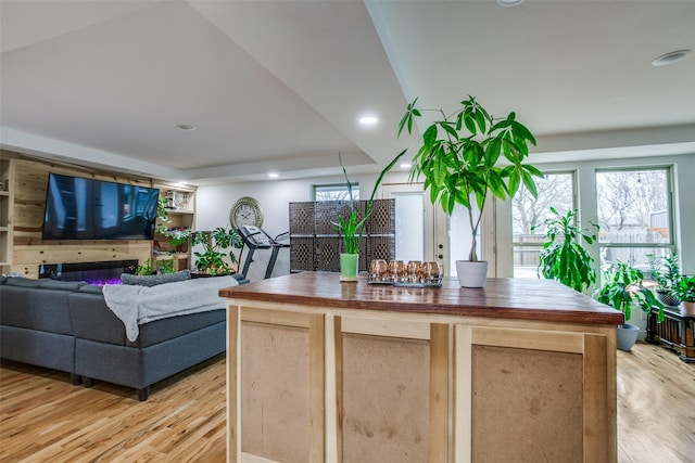 kitchen featuring recessed lighting, light wood-style floors, open floor plan, and butcher block counters