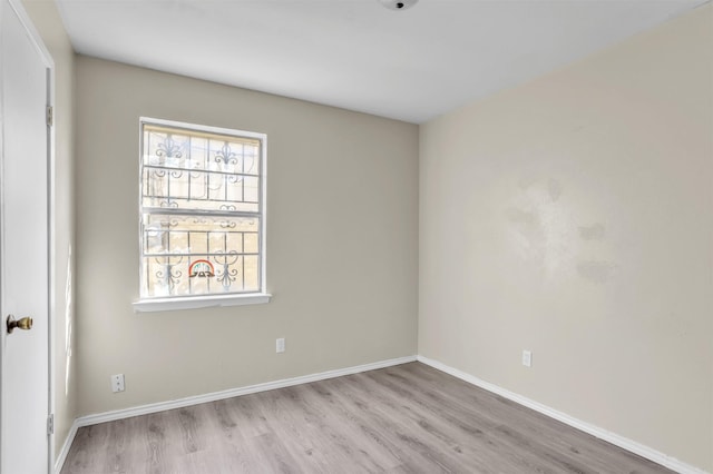 empty room with wood finished floors and baseboards