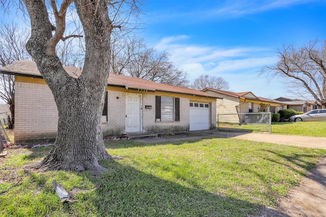 view of front of property with brick siding, driveway, a front lawn, and a garage