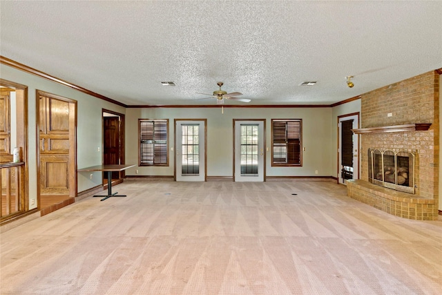 unfurnished living room with visible vents, a fireplace, light colored carpet, and baseboards