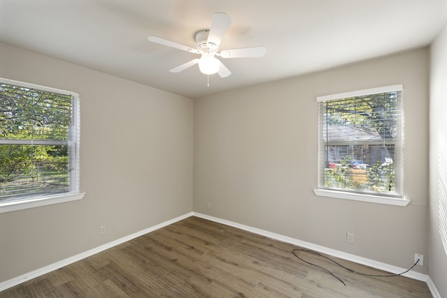 unfurnished room with ceiling fan, baseboards, and wood finished floors