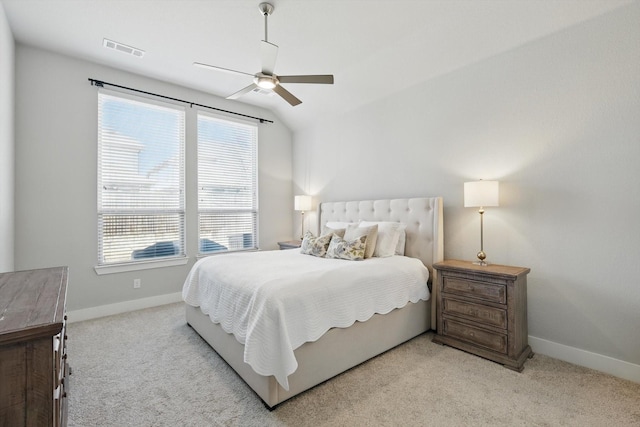 bedroom featuring light colored carpet, baseboards, visible vents, and ceiling fan