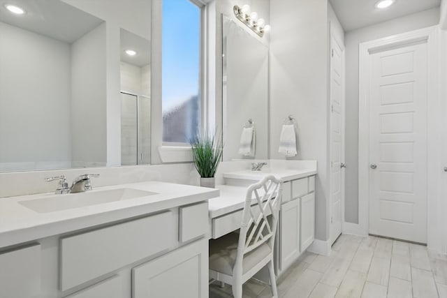 full bathroom with recessed lighting, a shower stall, and vanity