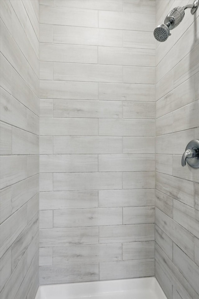 bathroom with a tile shower