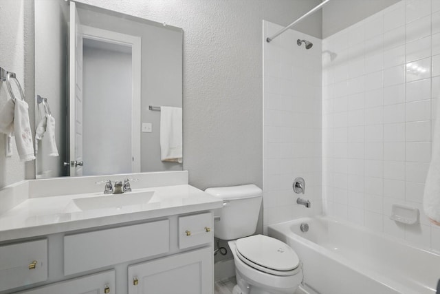 full bathroom featuring vanity, bathing tub / shower combination, toilet, and a textured wall