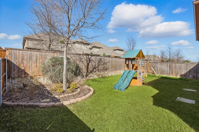 view of play area with a yard and a fenced backyard