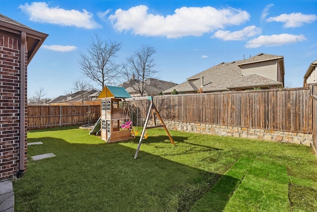 view of yard with a playground and a fenced backyard