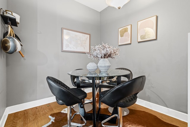 dining area featuring wood finished floors and baseboards