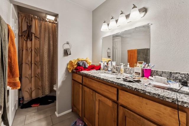 bathroom featuring tile patterned floors, toilet, a shower with shower curtain, and vanity