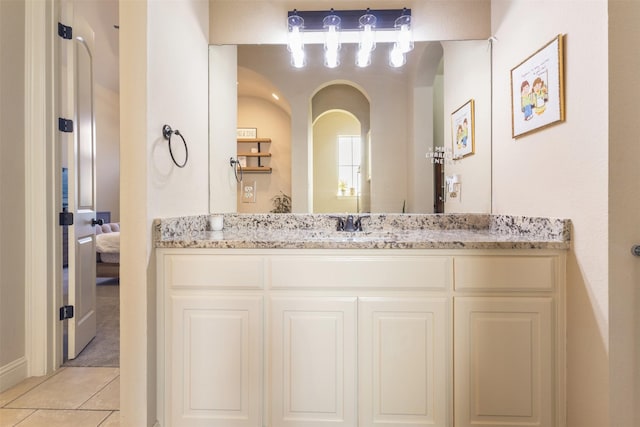 bathroom featuring tile patterned floors, ensuite bath, and vanity