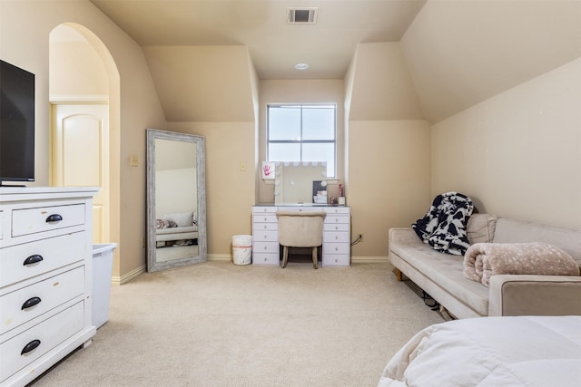 bedroom featuring visible vents, light colored carpet, baseboards, and vaulted ceiling