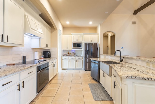 kitchen with visible vents, light tile patterned flooring, black appliances, white cabinetry, and tasteful backsplash