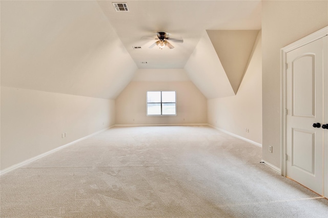 additional living space with visible vents, ceiling fan, baseboards, carpet, and vaulted ceiling