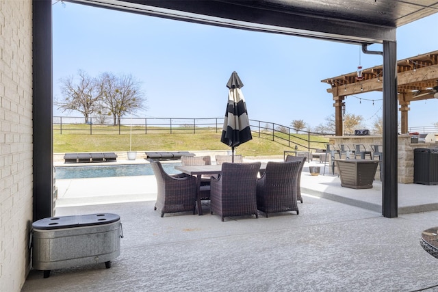 view of patio / terrace with outdoor dining space, a fenced backyard, and an outdoor pool