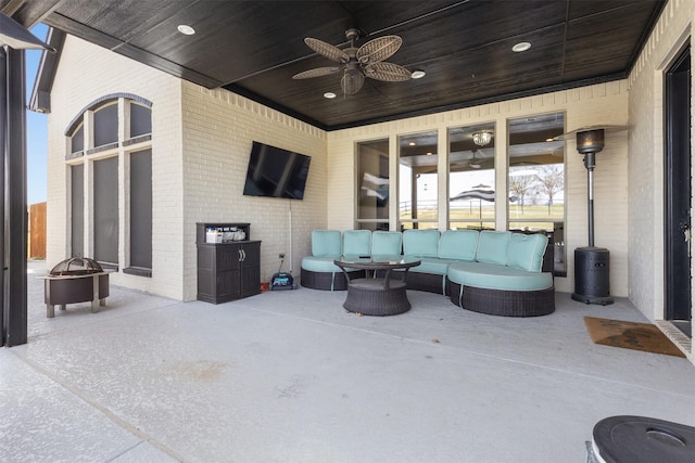 view of patio featuring an outdoor living space with a fire pit and ceiling fan