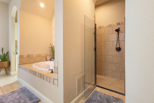 bathroom featuring tile patterned floors, visible vents, tiled shower, and a garden tub