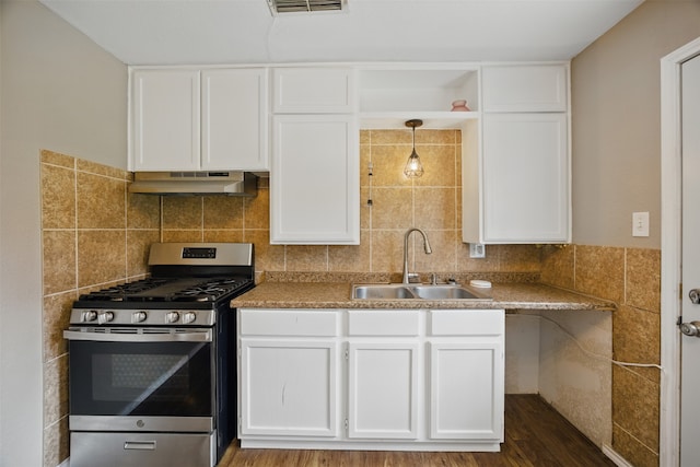 kitchen featuring white cabinetry, stainless steel gas stove, under cabinet range hood, and a sink